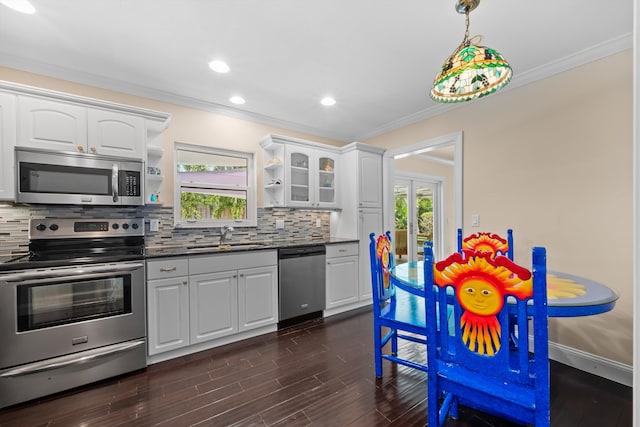 kitchen featuring appliances with stainless steel finishes, a sink, open shelves, ornamental molding, and tasteful backsplash