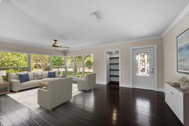 living area with plenty of natural light, wood-type flooring, ceiling fan, ornamental molding, and baseboards