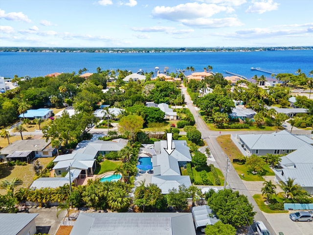 aerial view of residential area featuring a large body of water