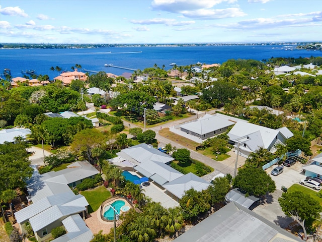 aerial perspective of suburban area with a nearby body of water and a pool area