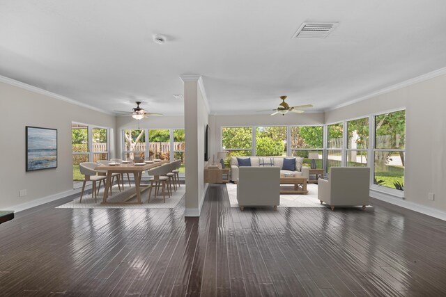 living area featuring a ceiling fan, baseboards, crown molding, and hardwood / wood-style floors