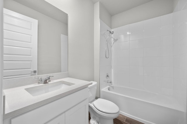 bathroom with vanity, wood finished floors, bathing tub / shower combination, and toilet