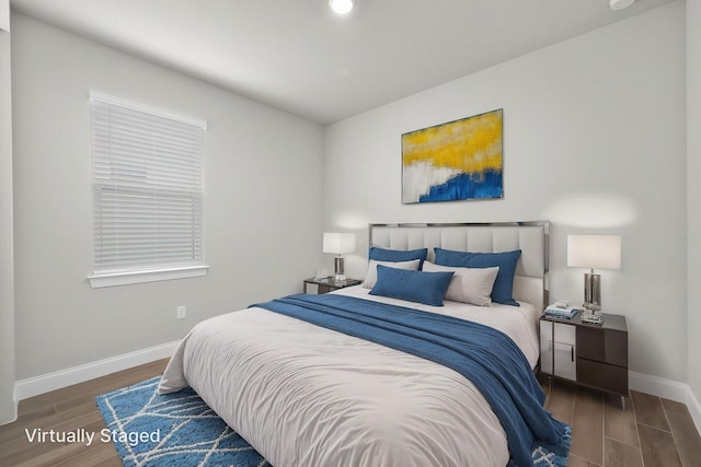 bedroom with baseboards, recessed lighting, and wood finished floors