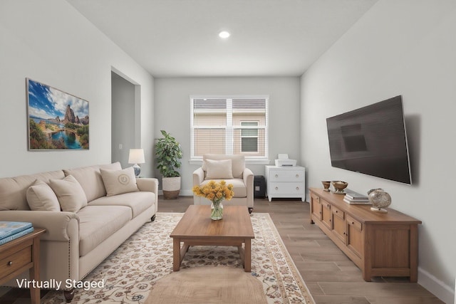 living area with recessed lighting, baseboards, and light wood-style floors