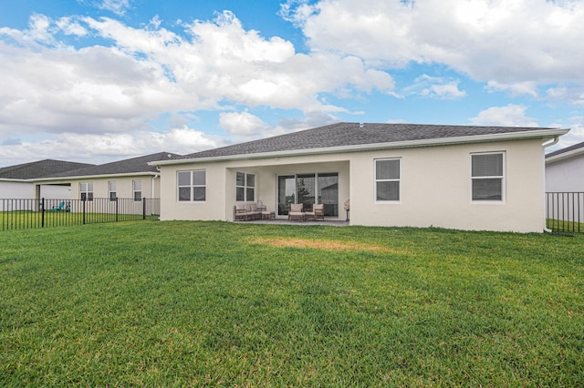 rear view of house with a lawn, a patio, a fenced backyard, and stucco siding
