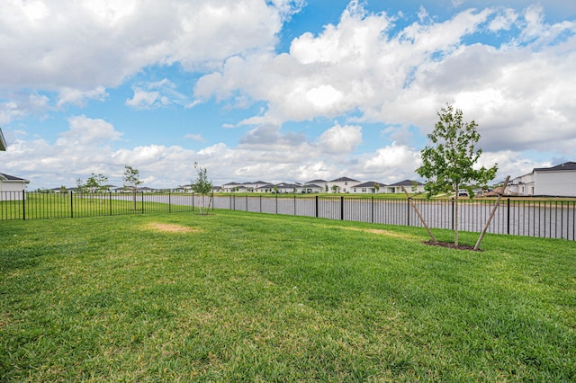 view of yard featuring a residential view and a fenced backyard