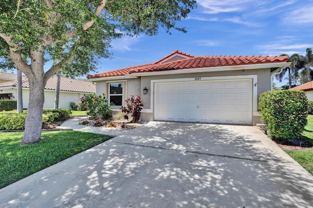 mediterranean / spanish-style house featuring a garage, a front lawn, stucco siding, a tiled roof, and driveway