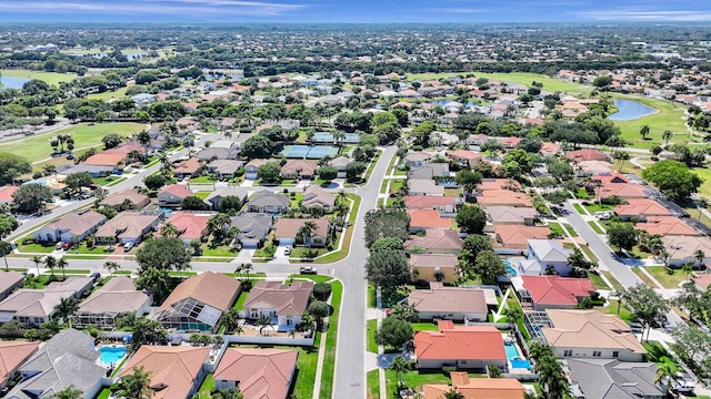 birds eye view of property with a water view, view of golf course, and a residential view