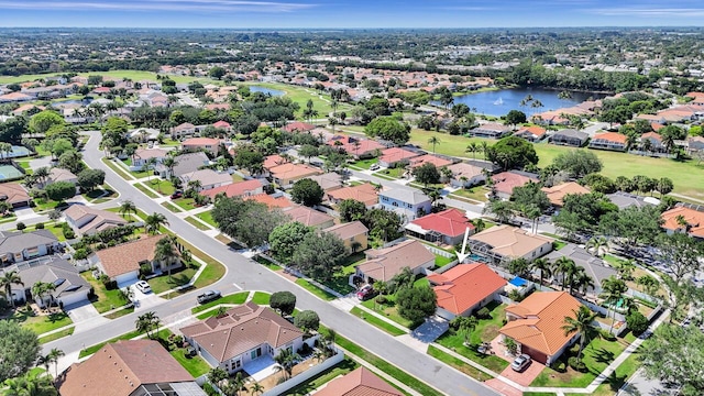 bird's eye view with a water view and a residential view
