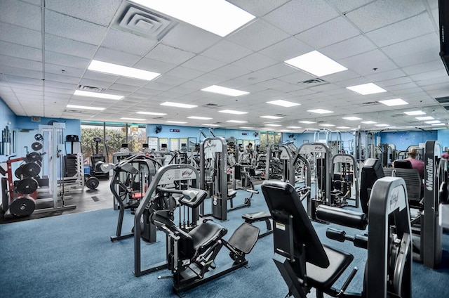 exercise room with a drop ceiling and visible vents