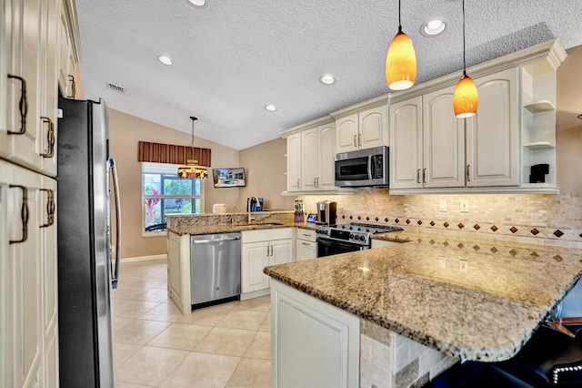 kitchen featuring backsplash, appliances with stainless steel finishes, vaulted ceiling, light tile patterned floors, and a peninsula