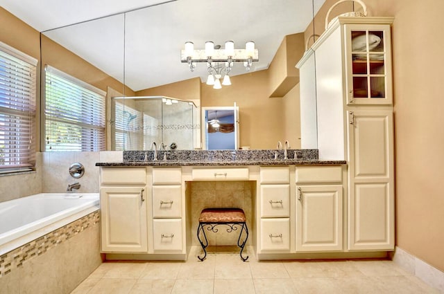 full bath featuring a garden tub, a sink, tile patterned floors, and a shower stall