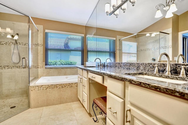 full bath with plenty of natural light, a sink, and a notable chandelier