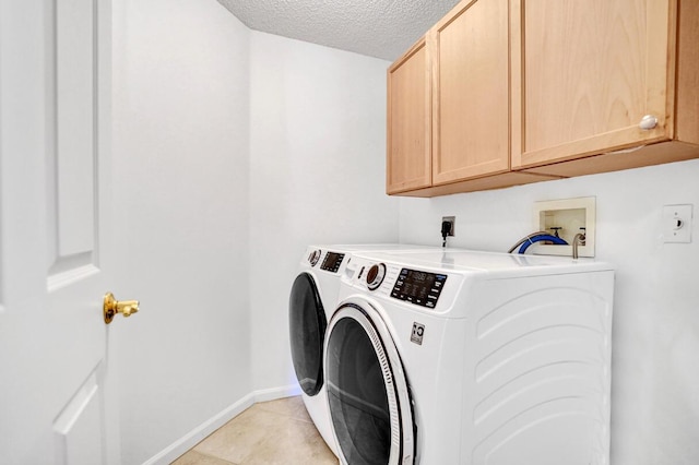 clothes washing area featuring washer and dryer, cabinet space, a textured ceiling, baseboards, and light tile patterned floors