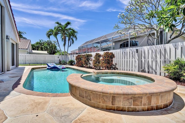 view of pool with a fenced backyard, a fenced in pool, and an in ground hot tub
