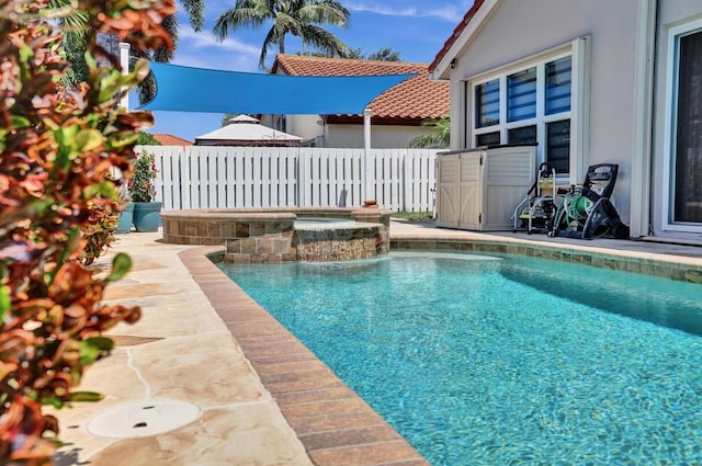 view of swimming pool with a fenced in pool, an in ground hot tub, and fence