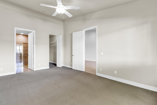 unfurnished bedroom with carpet floors, baseboards, and visible vents