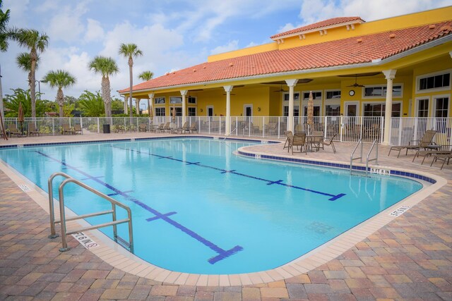pool featuring a ceiling fan, a patio area, and fence