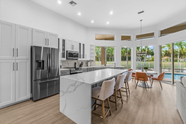 kitchen featuring visible vents, light wood-style floors, appliances with stainless steel finishes, and a healthy amount of sunlight