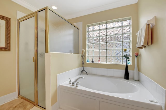 bathroom with a bath, a shower stall, healthy amount of natural light, and ornamental molding