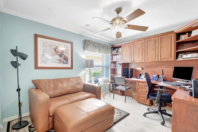 home office with a ceiling fan, ornamental molding, built in desk, and light tile patterned flooring