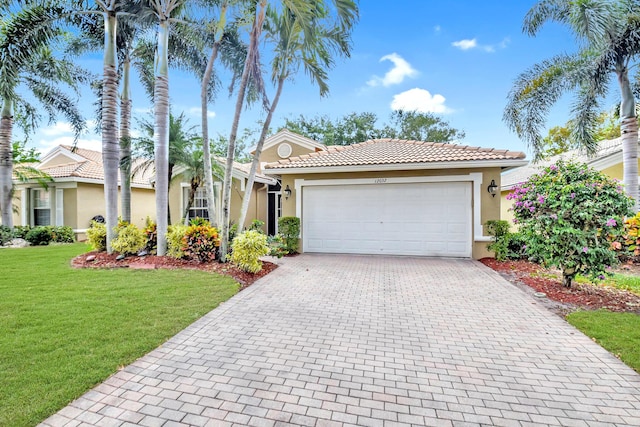 view of front facade with stucco siding, a tiled roof, decorative driveway, a front lawn, and an attached garage
