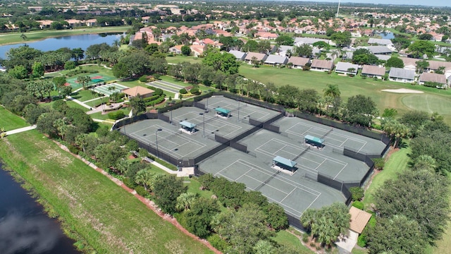 aerial view of property's location featuring a nearby body of water and nearby suburban area