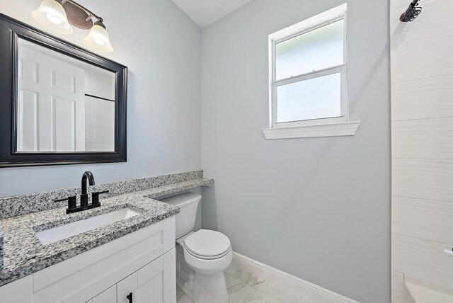 full bathroom featuring vanity, marble finish floor, a shower, toilet, and baseboards