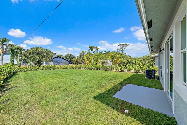 view of yard featuring central AC unit and a patio area