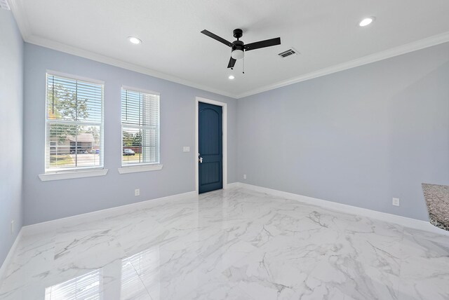 empty room with crown molding, baseboards, visible vents, and ceiling fan