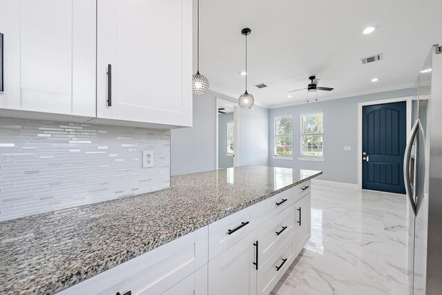 kitchen featuring a ceiling fan, visible vents, tasteful backsplash, ornamental molding, and white cabinetry