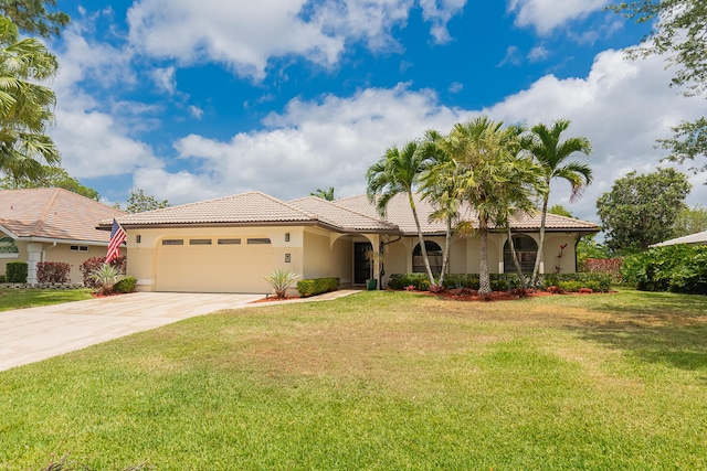 view of front facade with concrete driveway, an attached garage, a tile roof, and stucco siding