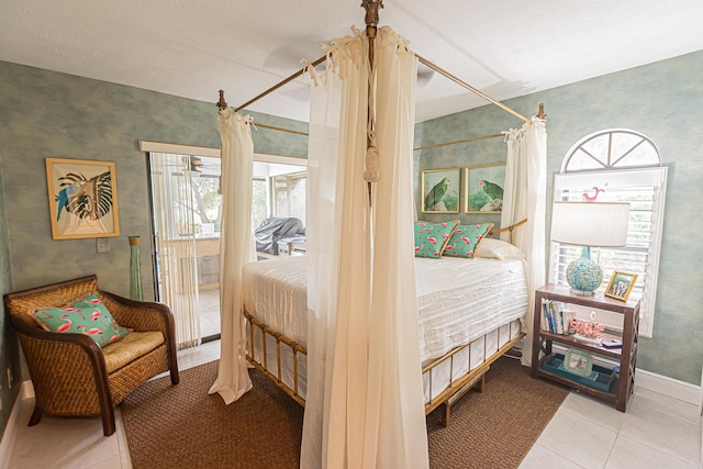 tiled bedroom with baseboards, ceiling fan, access to exterior, and wallpapered walls