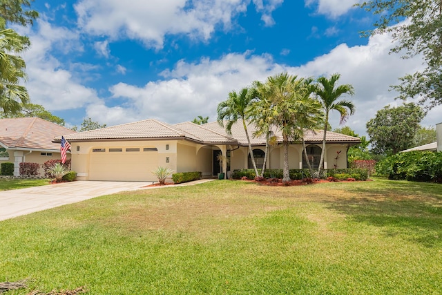 view of front of home featuring an attached garage, stucco siding, driveway, and a tile roof