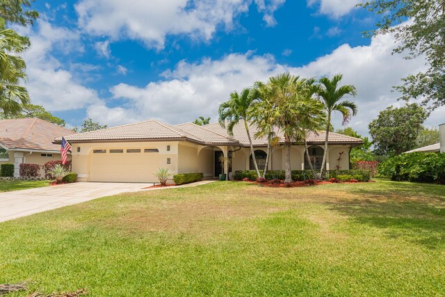 1333 SW Cedar Cv, Port Saint Lucie, FL 34986 - view of front of home featuring a tile roof, stucco siding, driveway, and an attached garage