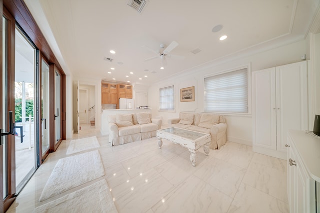 living room with crown molding, ceiling fan, visible vents, and marble finish floor