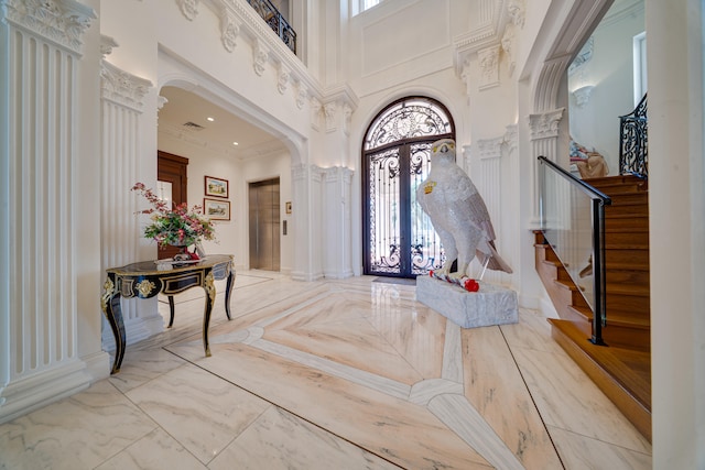 entrance foyer with stairway, a high ceiling, french doors, and a healthy amount of sunlight