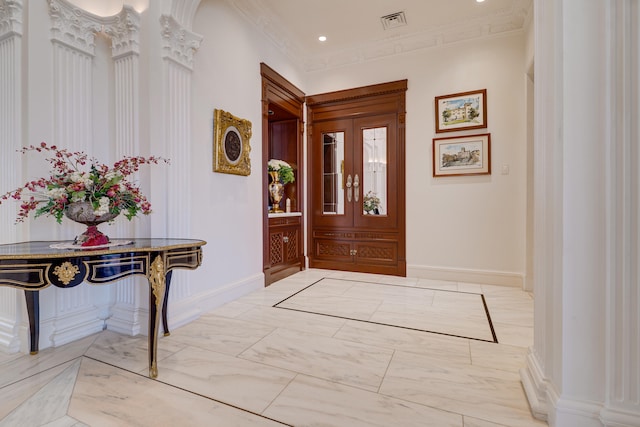 foyer entrance with visible vents, baseboards, marble finish floor, ornamental molding, and recessed lighting
