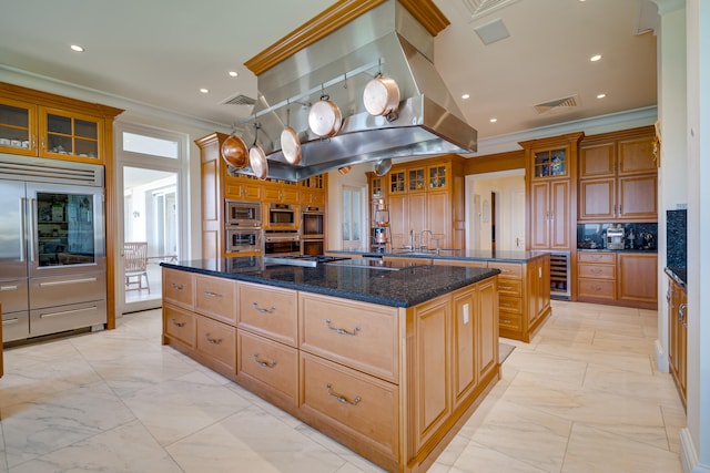kitchen with island exhaust hood, visible vents, a spacious island, marble finish floor, and ornamental molding