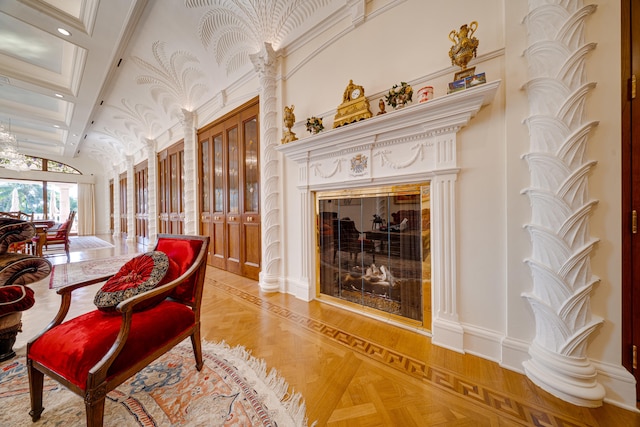 living area with a glass covered fireplace, high vaulted ceiling, and french doors