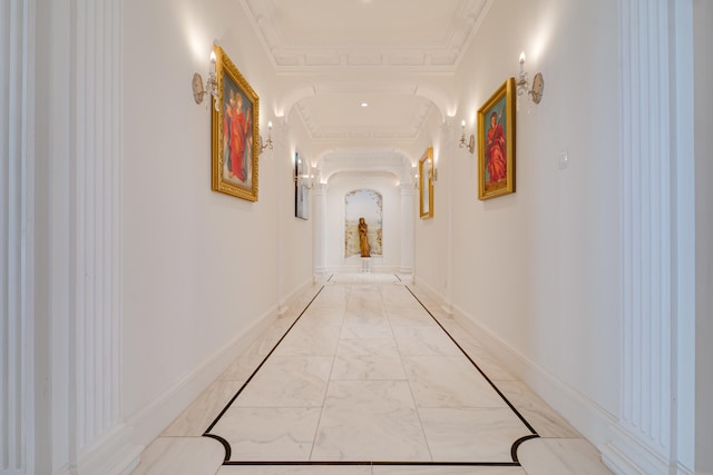 corridor featuring baseboards, arched walkways, marble finish floor, and ornamental molding