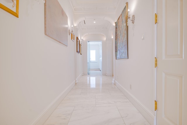 hall with baseboards, arched walkways, marble finish floor, and ornamental molding