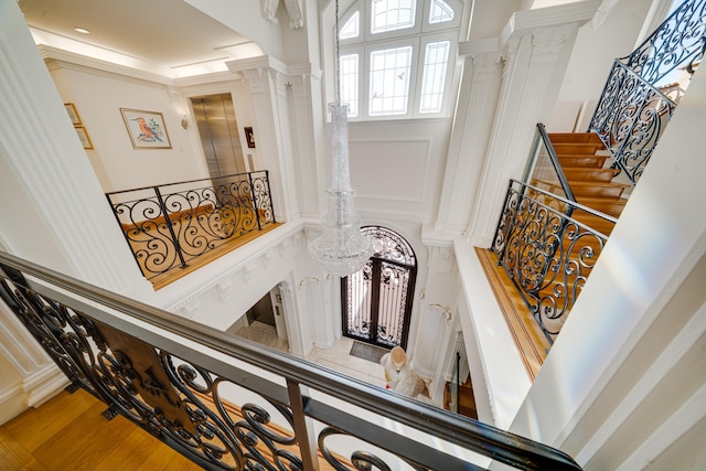 stairs featuring ornate columns and a towering ceiling