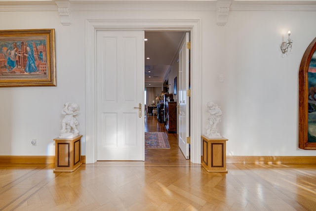 interior space with arched walkways, baseboards, and ornamental molding