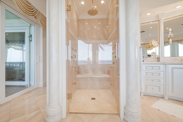 full bath with ornate columns, vanity, and a shower stall