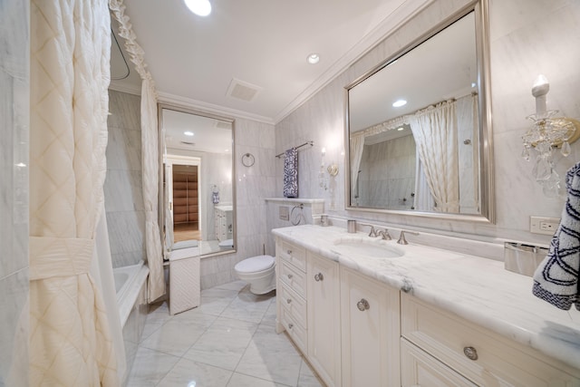 bathroom with vanity, a bathing tub, toilet, marble finish floor, and ornamental molding