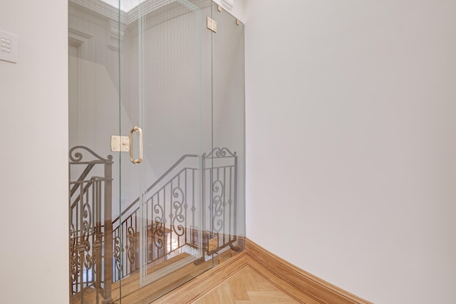 stairs featuring crown molding and baseboards