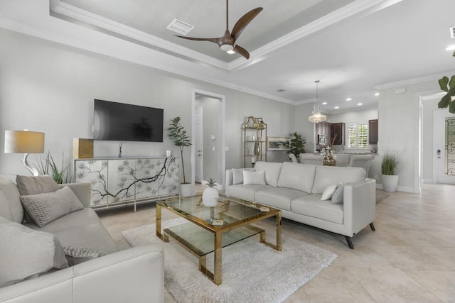 10245 SW Reggiani Rd, Port Saint Lucie, FL 34986 - living room featuring crown molding, a ceiling fan, a tray ceiling, and visible vents