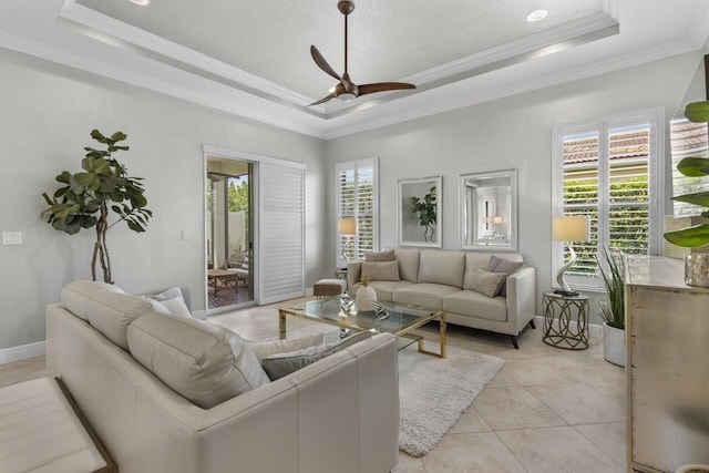 10245 SW Reggiani Rd, Port Saint Lucie, FL 34986 - living area with crown molding, a ceiling fan, baseboards, light tile patterned floors, and a tray ceiling