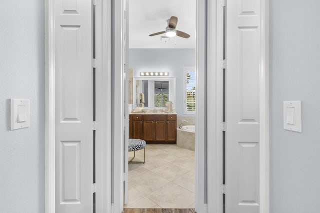 10245 SW Reggiani Rd, Port Saint Lucie, FL 34986 - hall featuring light tile patterned floors and a sink